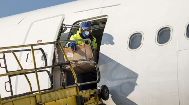 A worker unloads boxes of protective masks from a plane at Frankfurt Airport in Germany on March 25.