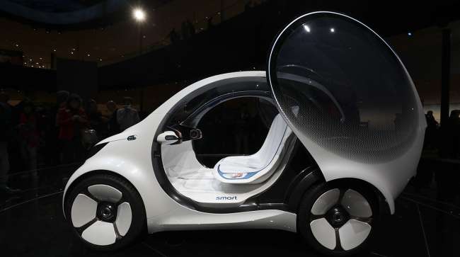 A door sits open on a Daimler Smart Vision EQ fortwo electric autonomous self-driving concept automobile.