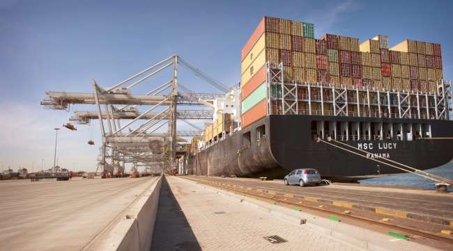 A massive containership docks at the Port of Rotterdam, the largest seaport in Europe