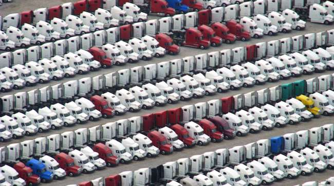 New Peterbilt trucks in a storage lot