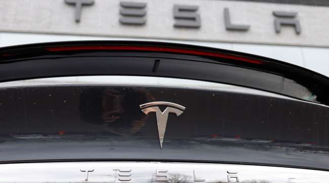 The Tesla company logo is seen on teh rear deck of an unsold 2020 Model X at a dealership in Colorado on April 26.