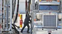 Worker fueling tanker truck